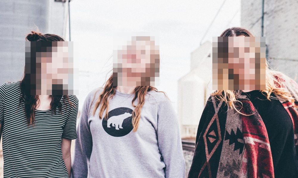 The same three faces pixelated into coarse blocks, the shape of each head still readable
